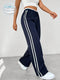 Women's navy blue sports pants with white stripes